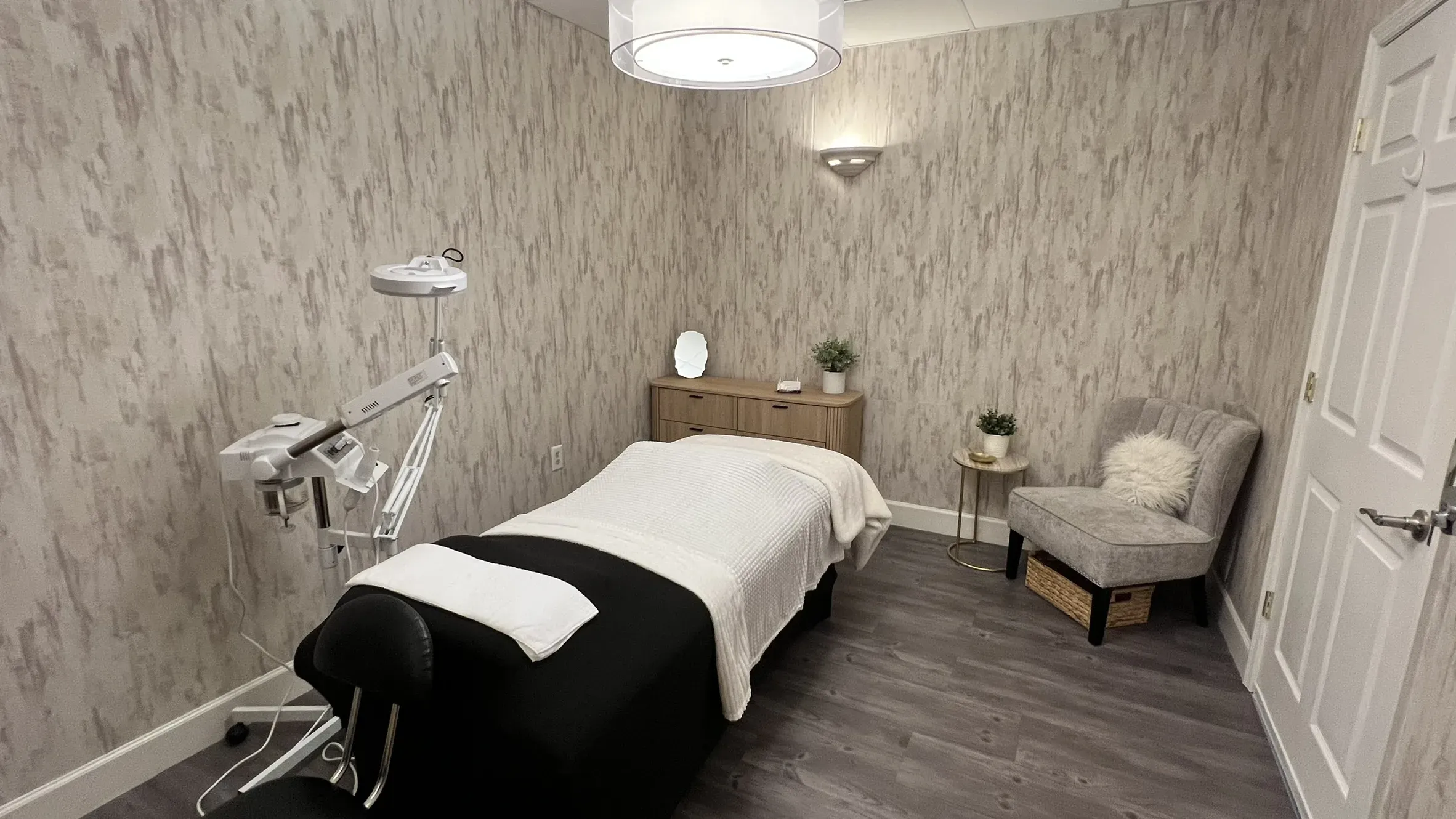 Treatment room at Elevé Esthetics with a facial bed and skincare equipment