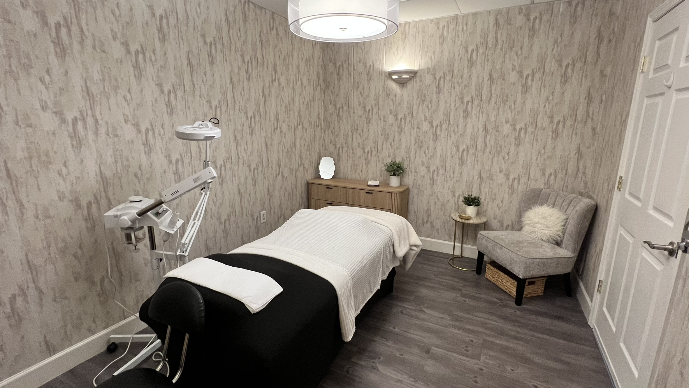 Treatment room at Elevé Esthetics with a facial bed and skincare equipment