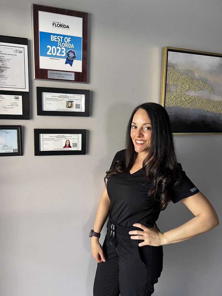 Esthetician Dina Abril beside her Florida esthetics licenses and Best of Florida 2023 award